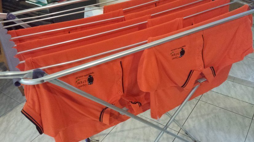 OpenSTEM polo shirts on rack